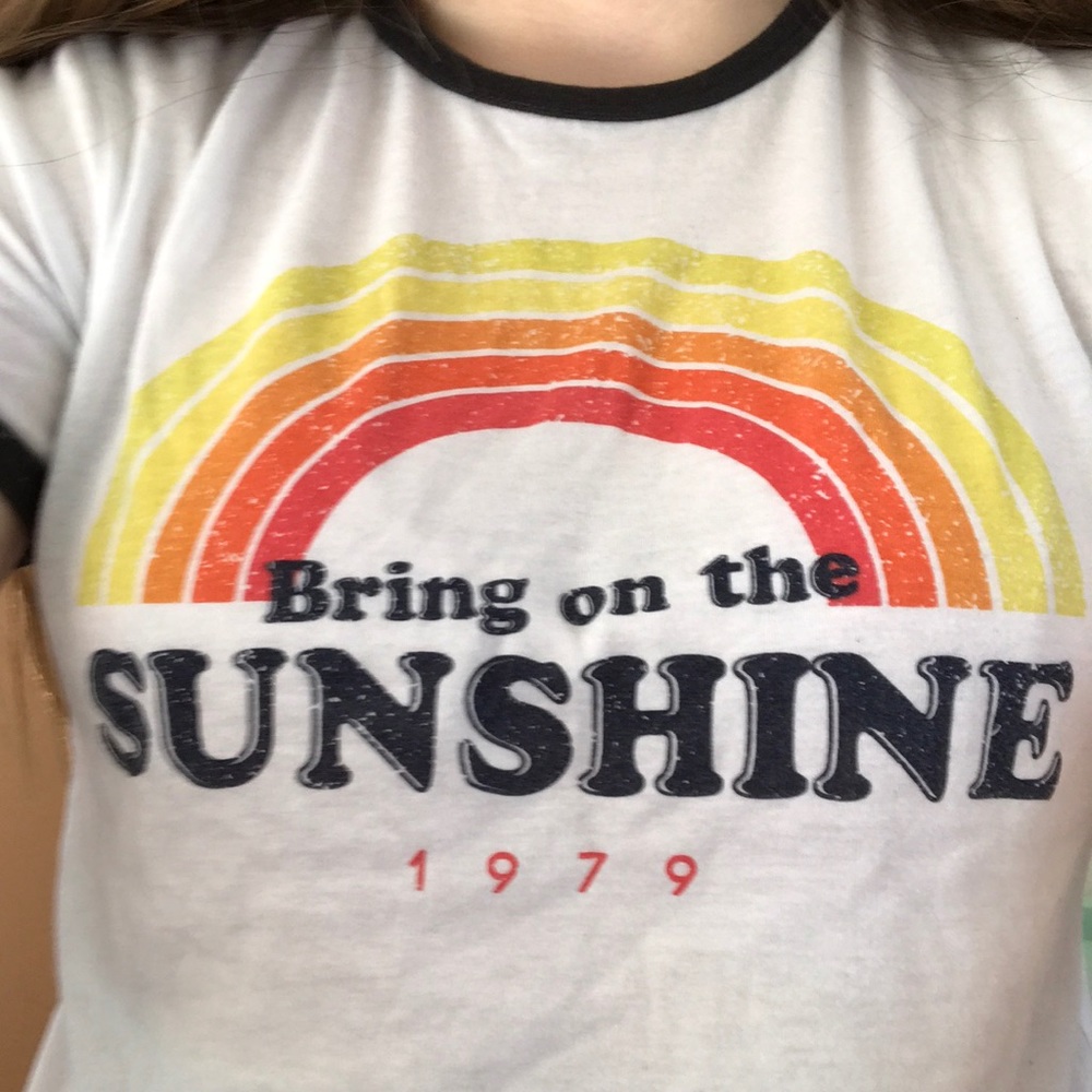 a white t shirt with a rainbow on it